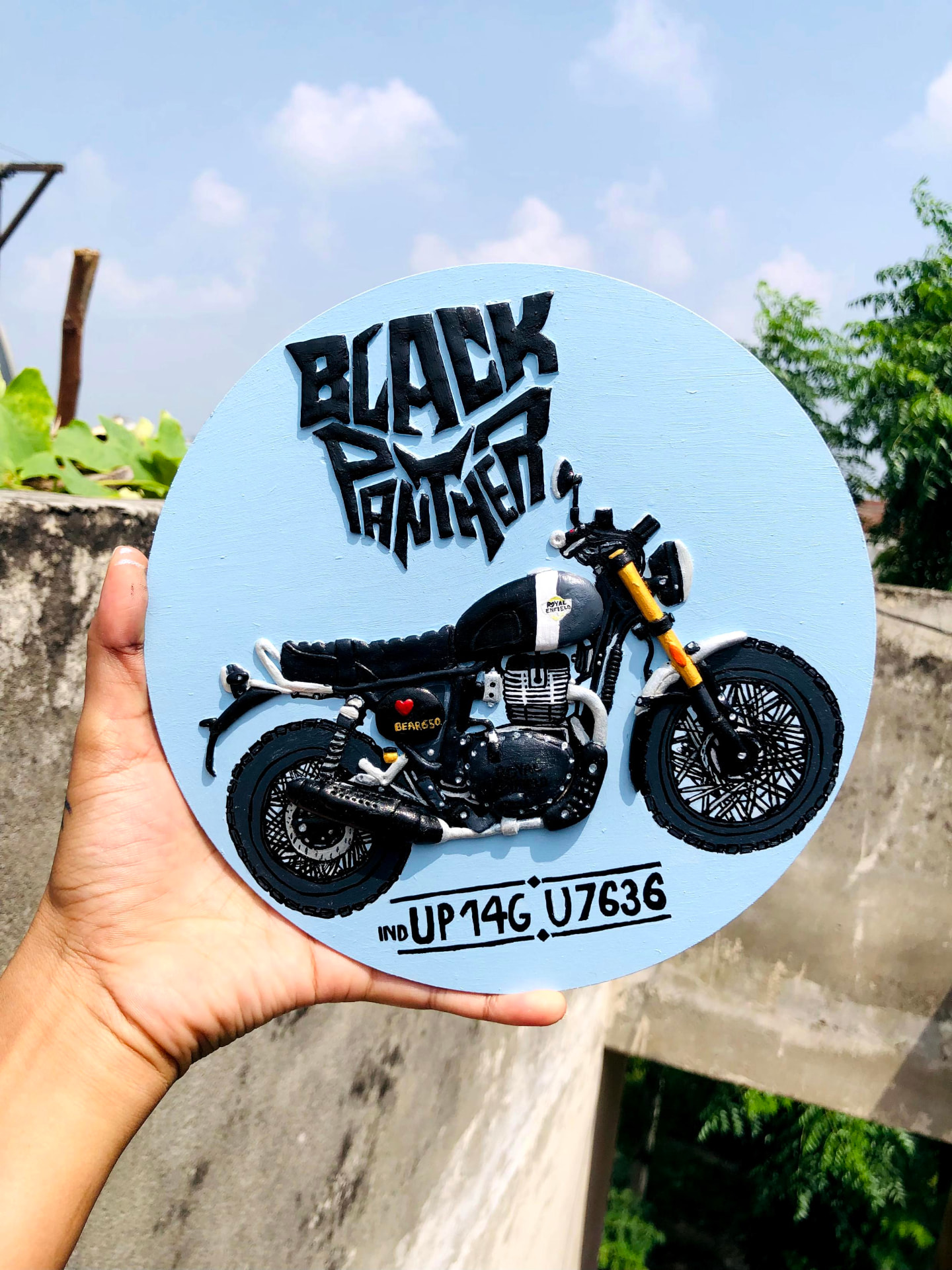 Custom Royal Enfield Lippan artwork with personalized lettering and hand visible